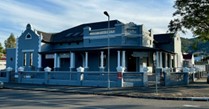 The sun setting over the beautiful offices of the practice of Annerie Beukes occupational therapists with a frontal view of the nostalgic building welcoming visitors with its warm embrace.