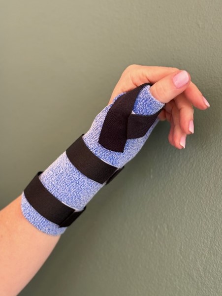 An image display an injured had strapped inside a custom made spint.